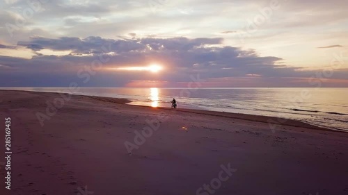 Wallpaper Mural Bike Ride Aerial. Young Man Riding Bicycle On A Sandy Beach At Sunset. Colorful Sunset On Sandy Beach. Shot From A Low Flying Drone. 4k Shot. Torontodigital.ca