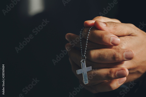 Close up hands holding Cross necklace.Pray for god blessing to wishing have a better life.praying for Get out of the coronavirus crisis