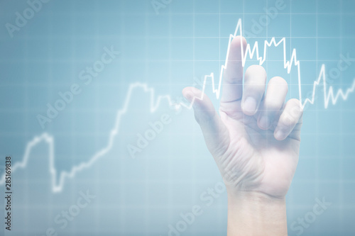Hand touching graphs of financial indicator and accounting market economy analysis chart