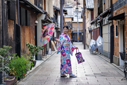 Women Floral Printed Long Kimono in Gion House is an old wooden, traditional style at Gion Shijo Kyoto Japan. photo