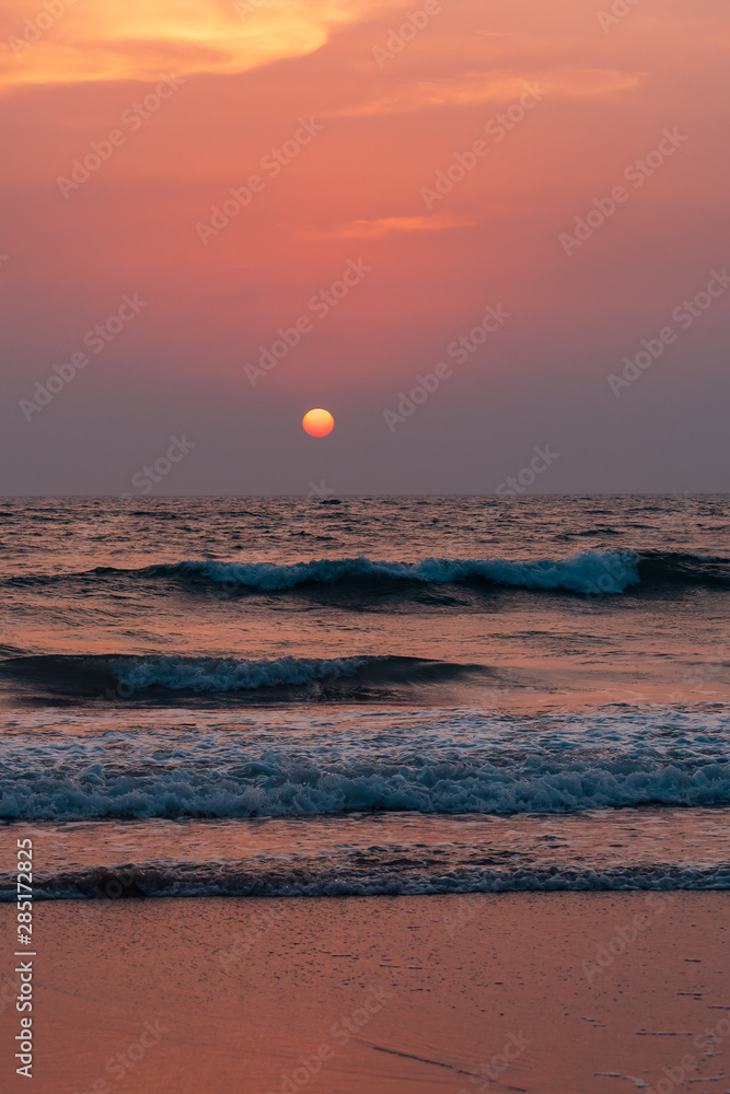 sunset at a beach, with yellow, pink and orange sky. sunset at a beach, with yellow, pink and orange sky.