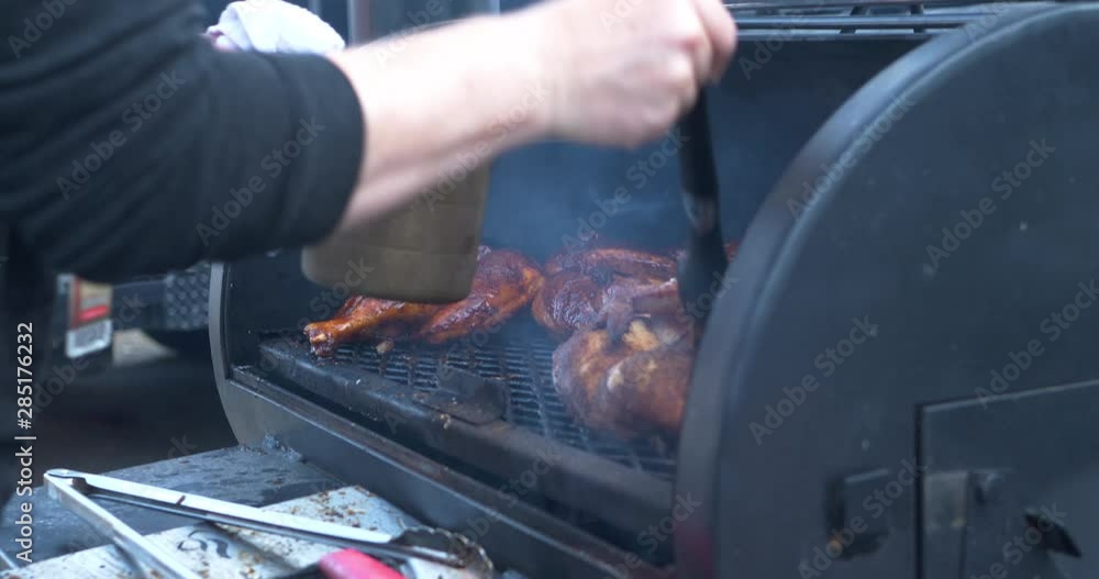 BBQ Chicken being sauced with BBQ Sauce on a smoking BBQ Pit. 4k BBQ Chicken being sauced with BBQ Sauce on a smoking BBQ Pit. 4k