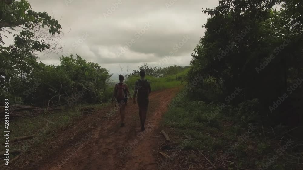 Man and women hiking in costa rica along a mountain range from aerial drone video Man and women hiking in costa rica along a mountain range from aerial drone video