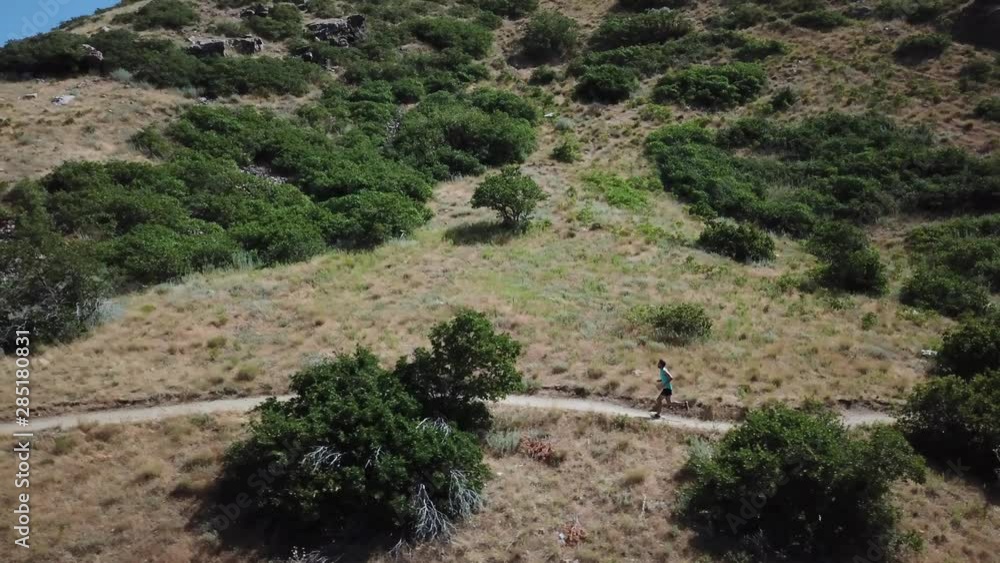 Drone Shot following an active man running on the outdoor Wasatch Mountain trails above Draper City, Utah. Drone Shot following an active man running on the outdoor Wasatch Mountain trails above Draper City, Utah.