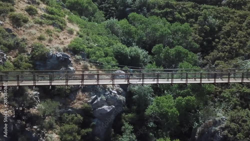 Drone Shot following an active man running on an outdoor hanging