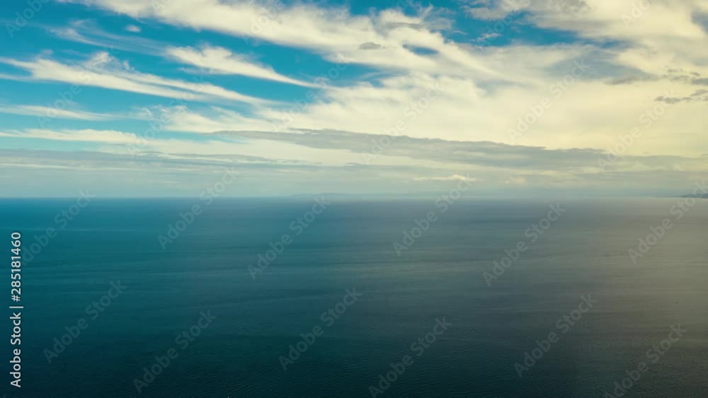 Hyperlapse: Sea surface with waves against the blue sky with clouds, timelapse, aerial view. Water cloud horizon background. Blue sea water with small waves against sky. Hyperlapse: Sea surface with waves against the blue sky with clouds, timelapse, aerial view. Water cloud horizon background. Blue sea water with small waves against sky.