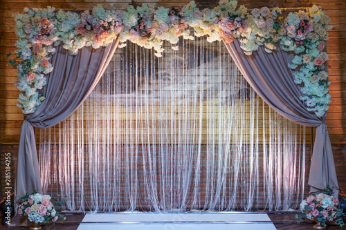 Wedding arch for wedding ceremony. Beautiful wedding decor in rustic style