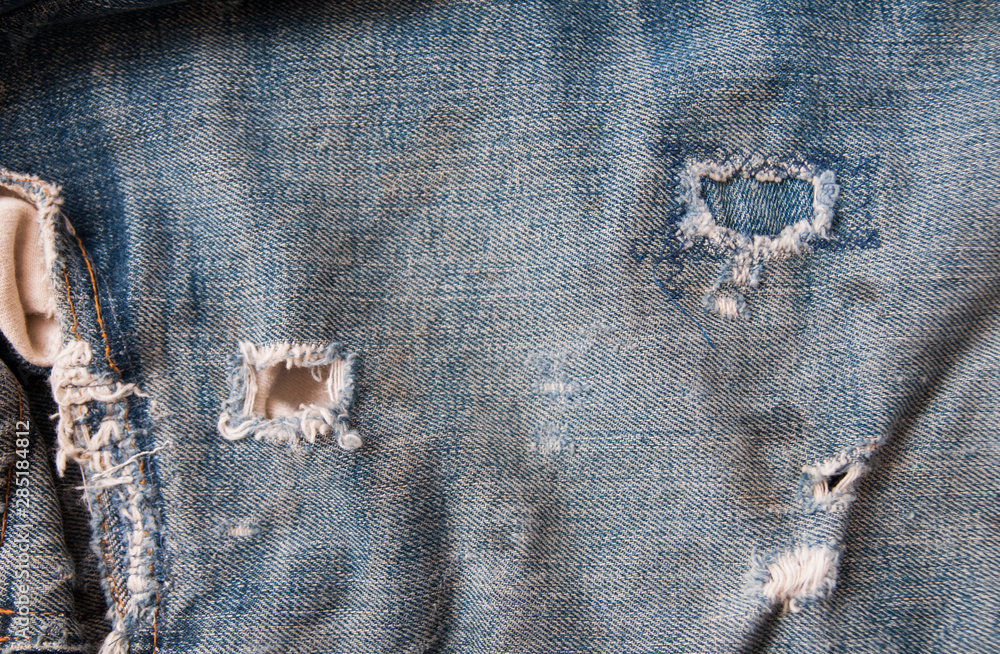 Fotografie Old jeans vintage levis Big E blue abstract background