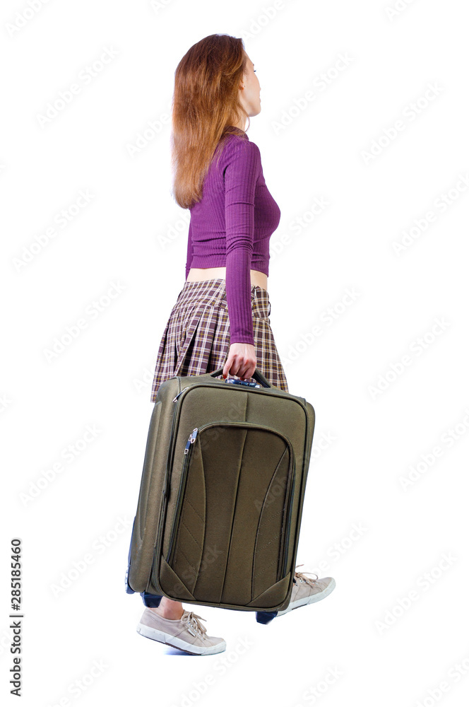 back view of walking woman with suitcase. back view of walking woman with suitcase.