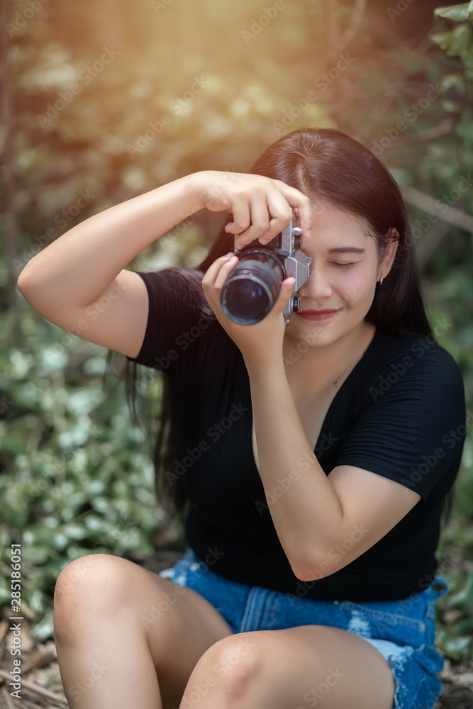 Portrait of asian woman is a professional photographer with mirrorless camera, outdoor portrait, free from copy space. Portrait of asian woman is a professional photographer with mirrorless camera, outdoor portrait, free from copy space.