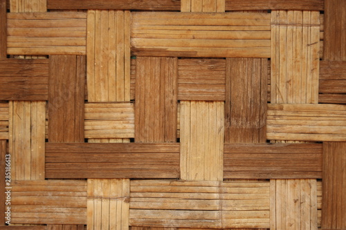 woven patterned bamboo matting wall in a traditional handmade rural hut in Northern Thailand  Southeast Asia