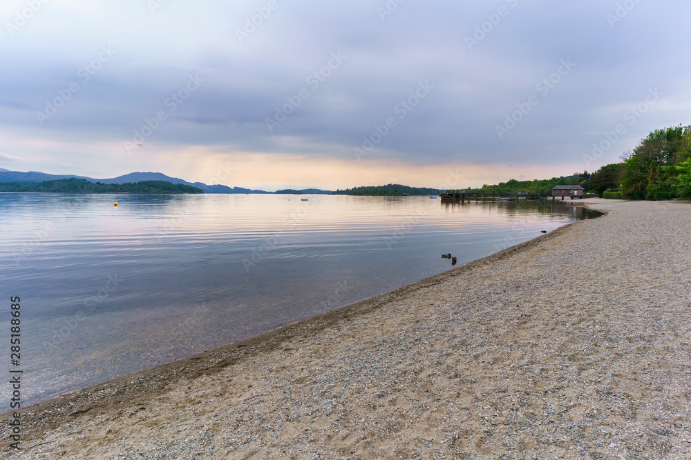 Beautiful Loch Lomond in The Trossachs National Park in the evening in summer , Luss , Scotland Beautiful Loch Lomond in The Trossachs National Park in the evening in summer , Luss , Scotland