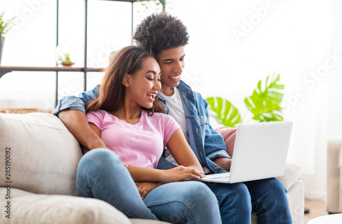Black couple making video call with their absent mate