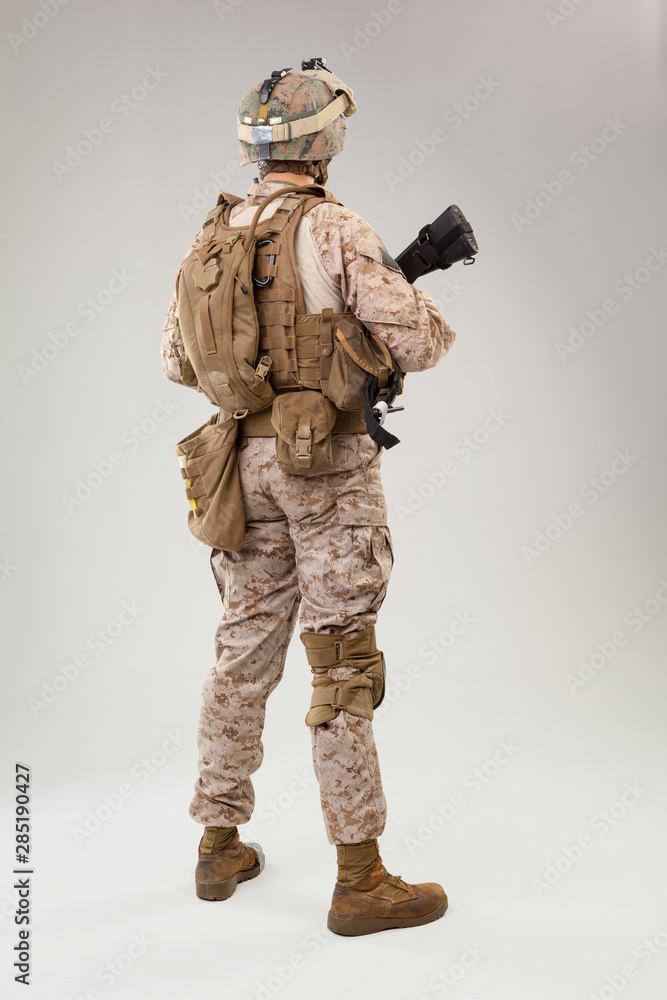 Rear view of military soldier US army marines operator studio shot portrait Rear view of military soldier US army marines operator studio shot portrait