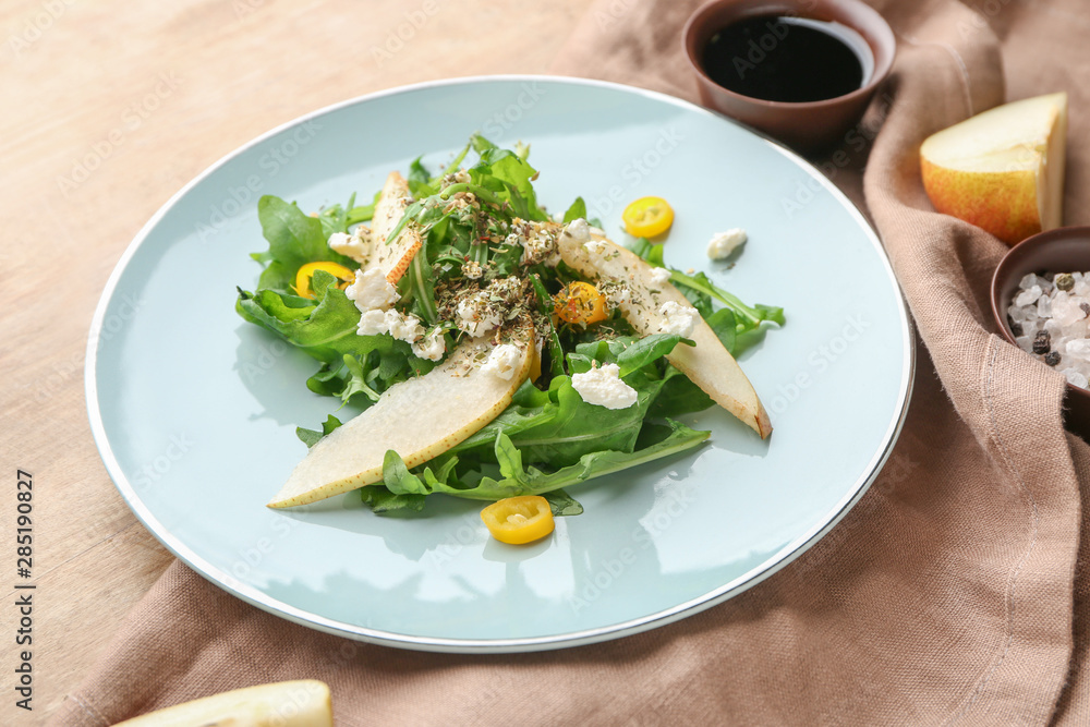 Plate with tasty arugula salad on table Plate with tasty arugula salad on table