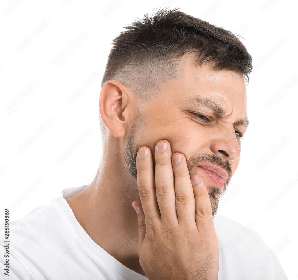 Man suffering from toothache against white background Man suffering from toothache against white background