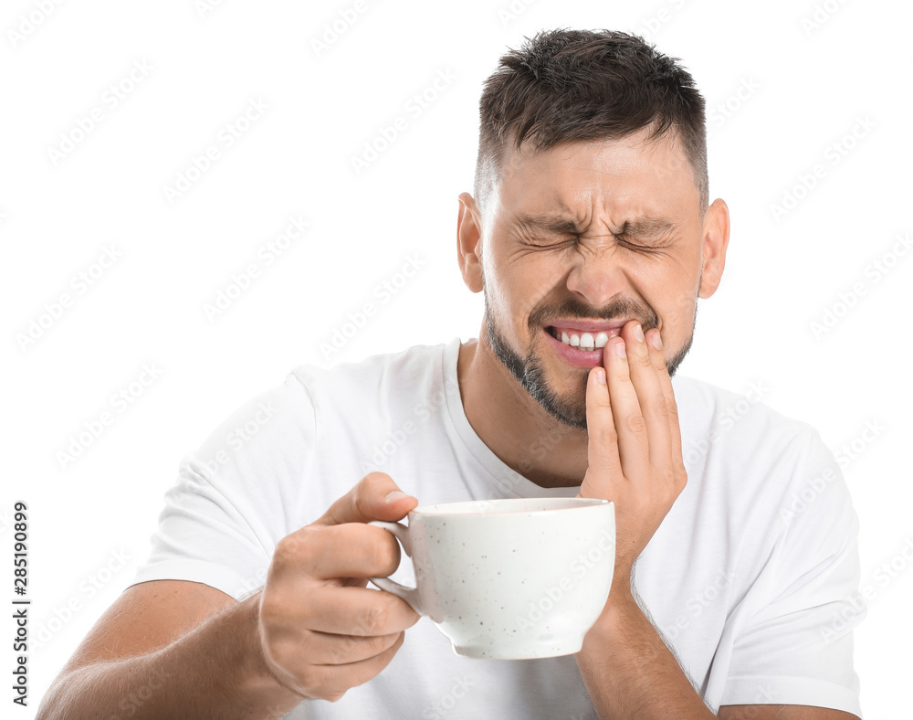 Man with sensitive teeth and cup of hot coffee on white background Man with sensitive teeth and cup of hot coffee on white background