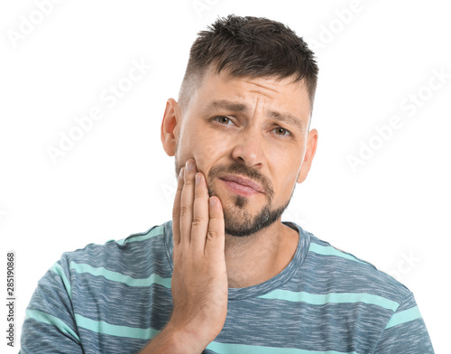 Man suffering from toothache against white background