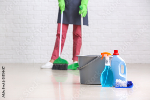 Set of cleaning supplies on floor in room