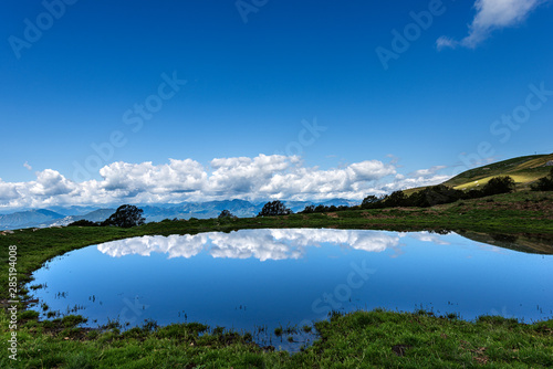 Small lake with reflections with sky and clouds, Monte Baldo, Italian Alps near Verona and lake Garda, Veneto, Italy, south Europe
