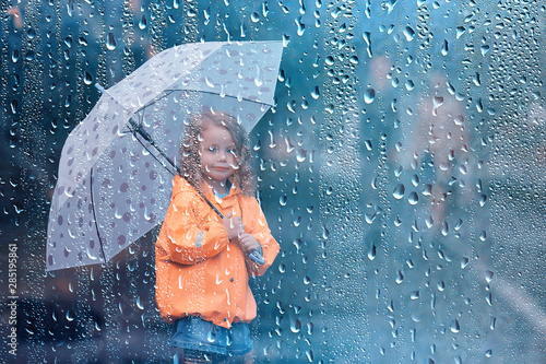 little girl with an umbrella / small child, rainy autumn walk, wet weather child with an umbrella © kichigin19