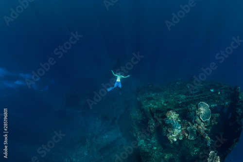 Freediver in the depth make ring bubble in underwater