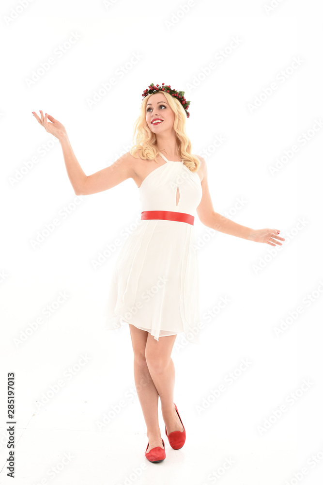 full length portrait of blonde girl wearing a white dress and flower crown. Standing pose, isolated against a white studio background. full length portrait of blonde girl wearing a white dress and flower crown. Standing pose, isolated against a white studio background.