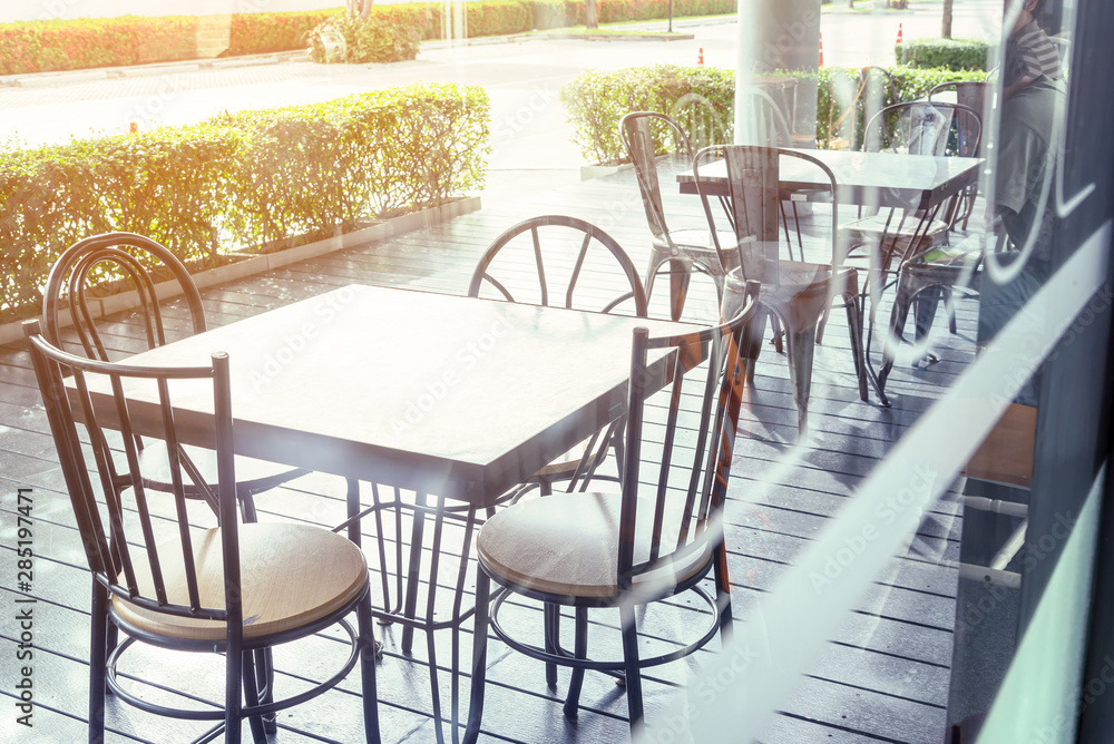 Outside shop in sunny day with tables and chairs of cafe , restaurant in the morning time which nobody uses them  .Outdoor of coffee shop exterior design concept - obrazy, fototapety, plakaty 