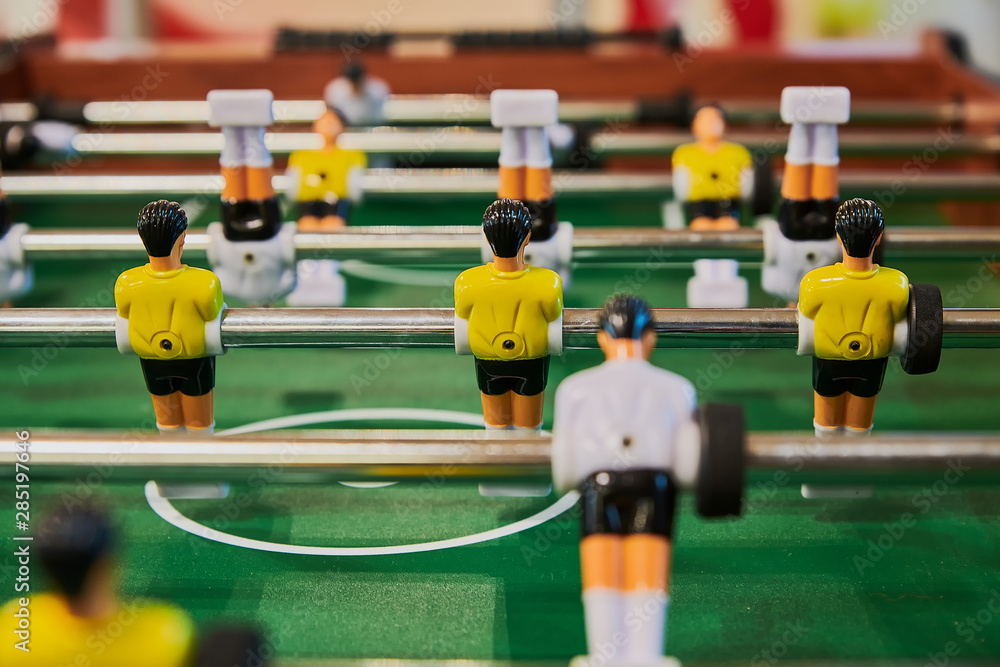 Table football, table football with close-ups of yellow and white players. Table football, table football with close-ups of yellow and white players.