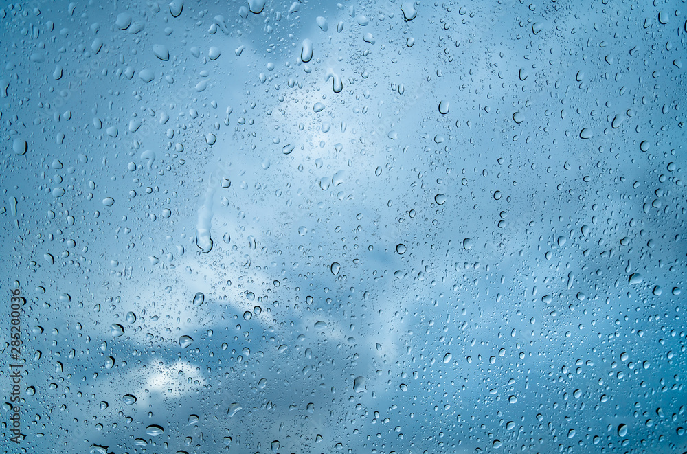 Fresh water drops after raining on blue glass window background in car. Fresh water drops after raining on blue glass window background in car.