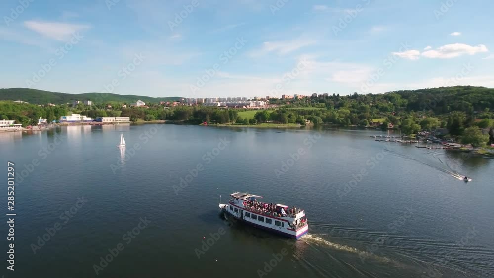 Aerial view of ferry with tourists on the lake, sunny day Aerial view of ferry with tourists on the lake, sunny day
