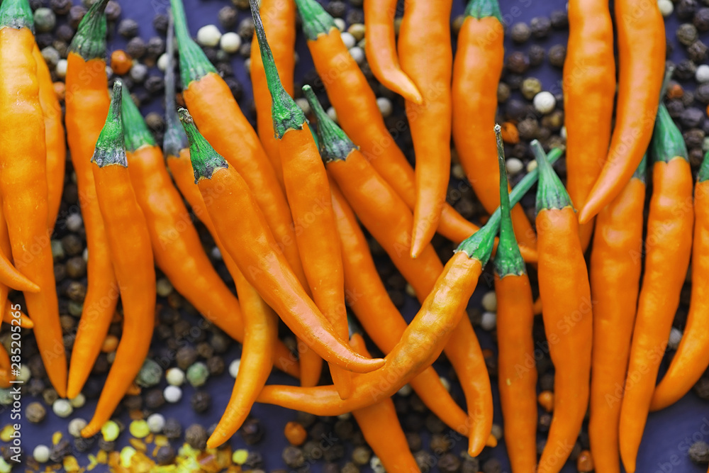 Hot orange pepper. Chilean pepper on a black. Hot orange pepper. Chilean pepper on a black.
