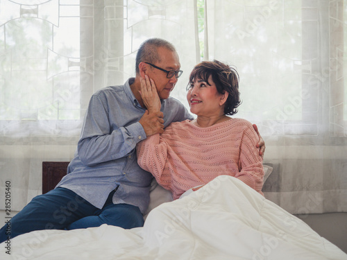 elder couples sit and rest in bed