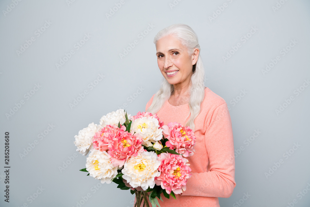 Photo portrait of nice positive glad sweet lovely dream dreamy wife holding big bouquet in hands from her husband isolated grey background Photo portrait of nice positive glad sweet lovely dream dreamy wife holding big bouquet in hands from her husband isolated grey background