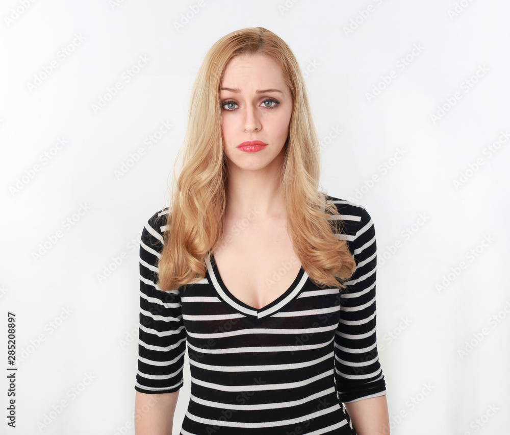 3/4 portrait of pretty blonde lady wearing stripes shirt, isolated against a white studio background. 3/4 portrait of pretty blonde lady wearing stripes shirt, isolated against a white studio background.