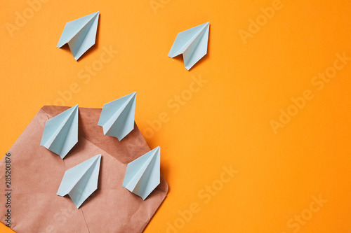 Concept for sending e-mails and e-commerce business. Email marketing. Paper planes flying out of the envelope photo