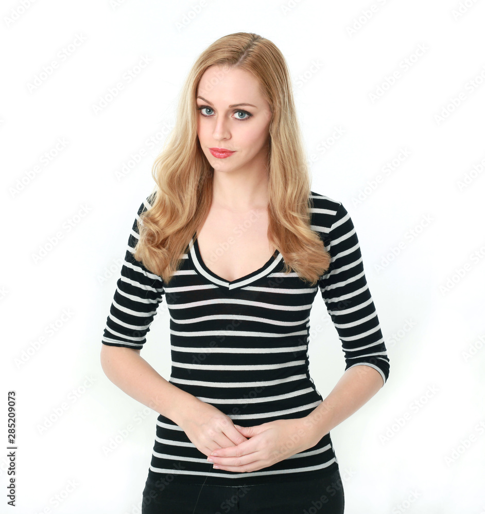 3/4 portrait of pretty blonde lady wearing stripes shirt, isolated against a white studio background. 3/4 portrait of pretty blonde lady wearing stripes shirt, isolated against a white studio background.