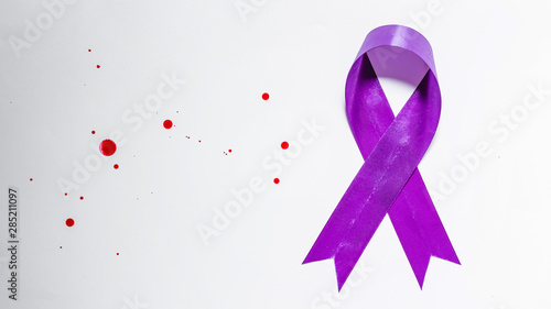 purple ribbon and blood drop on white background, domestic violence awareness concept photo