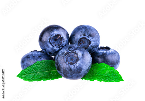 Blueberries in close up. Stack of blueberries with mint leaf isolated on white.