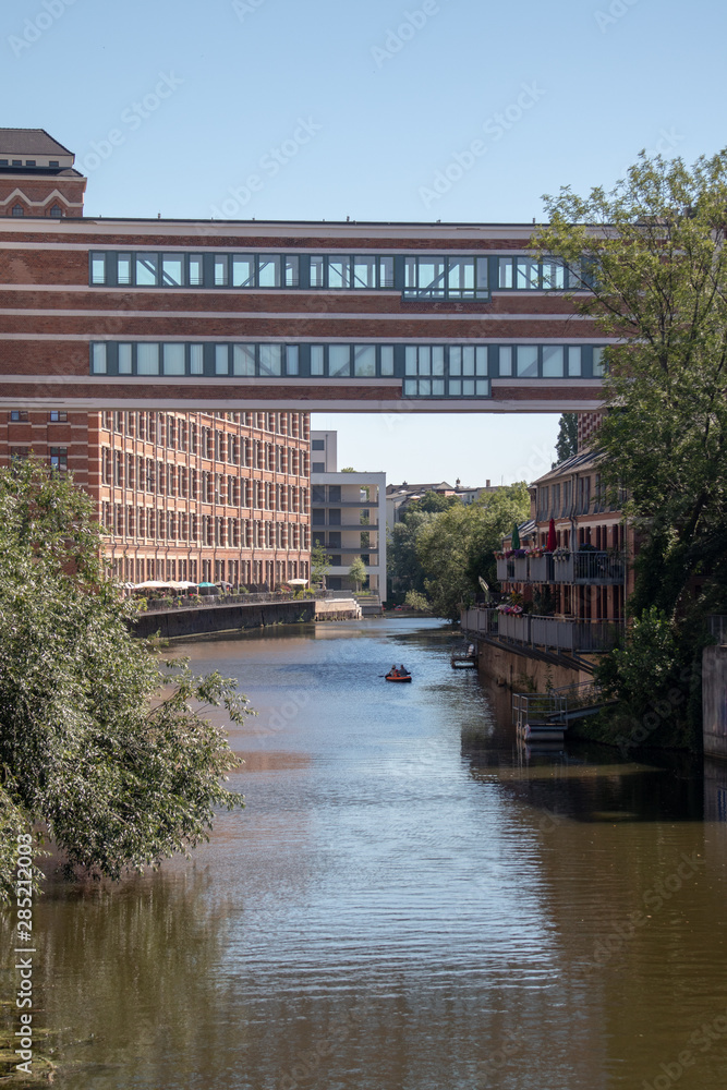 Picture from the river elster in leipzig Schleussig  .It is a popular place of residens in modern architectur in old buildings with name  buntgarnwerke .This is a beautiful place for watersports .