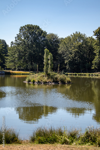 View of an idyllic park landscape in Leipzig,Germany with a pond with island