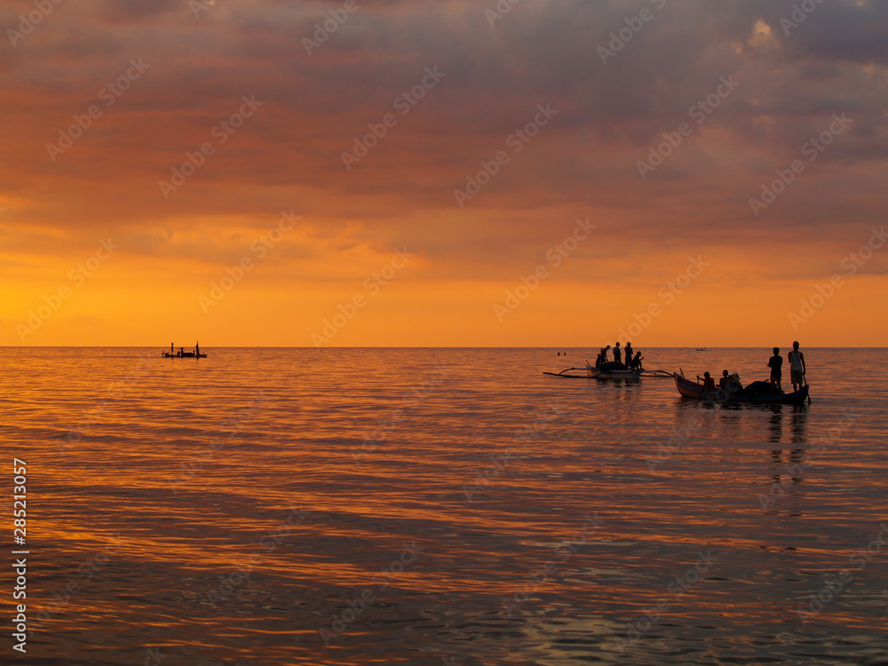 silhouette of boat on the beach during sunset