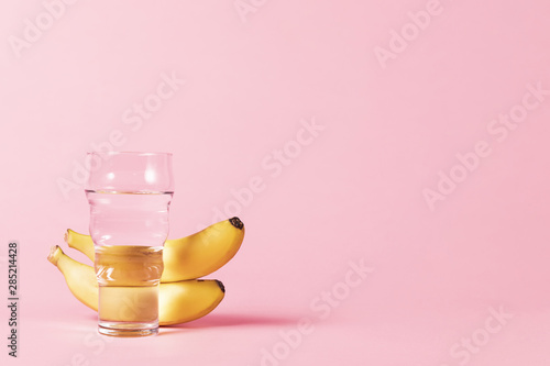 Bananas and water glass copy space