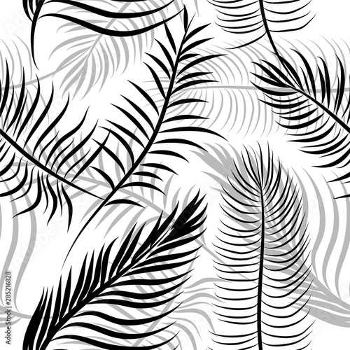 A seamless background of palm leaves. Vector illustration