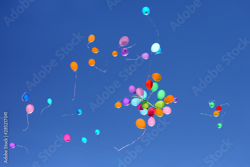large number of colorful balloons against the blue sky