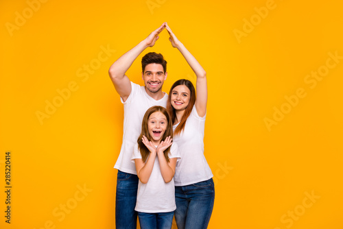 Daddy mommy and little foxy lady under protection on arms roof wear casual outfit isolated yellow background