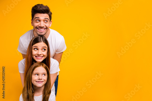 Portrait of three nice attractive charming lovely cute cheerful cheery person in order of hierarchy duty looking aside copy space isolated over bright vivid shine yellow background
