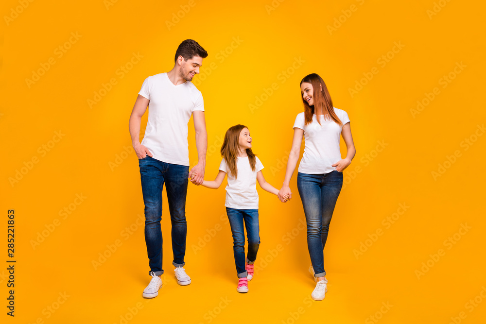Full length body size view of three nice attractive lovely stylish trendy cheerful cheery carefree person holding hands spending free time strolling isolated on bright vivid shine yellow background