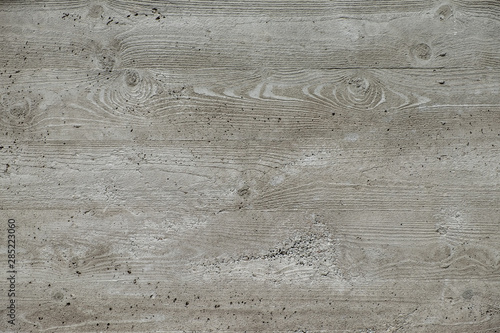 Concrete surface with wooden planks texture, with a pronounced element