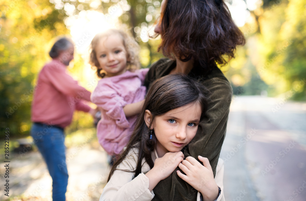 Beautiful young family with small children on a walk in autumn forest. Beautiful young family with small children on a walk in autumn forest.